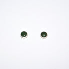A pair of small round stud earrings with dark green cabochon stones in silver, shown on a plain white background.