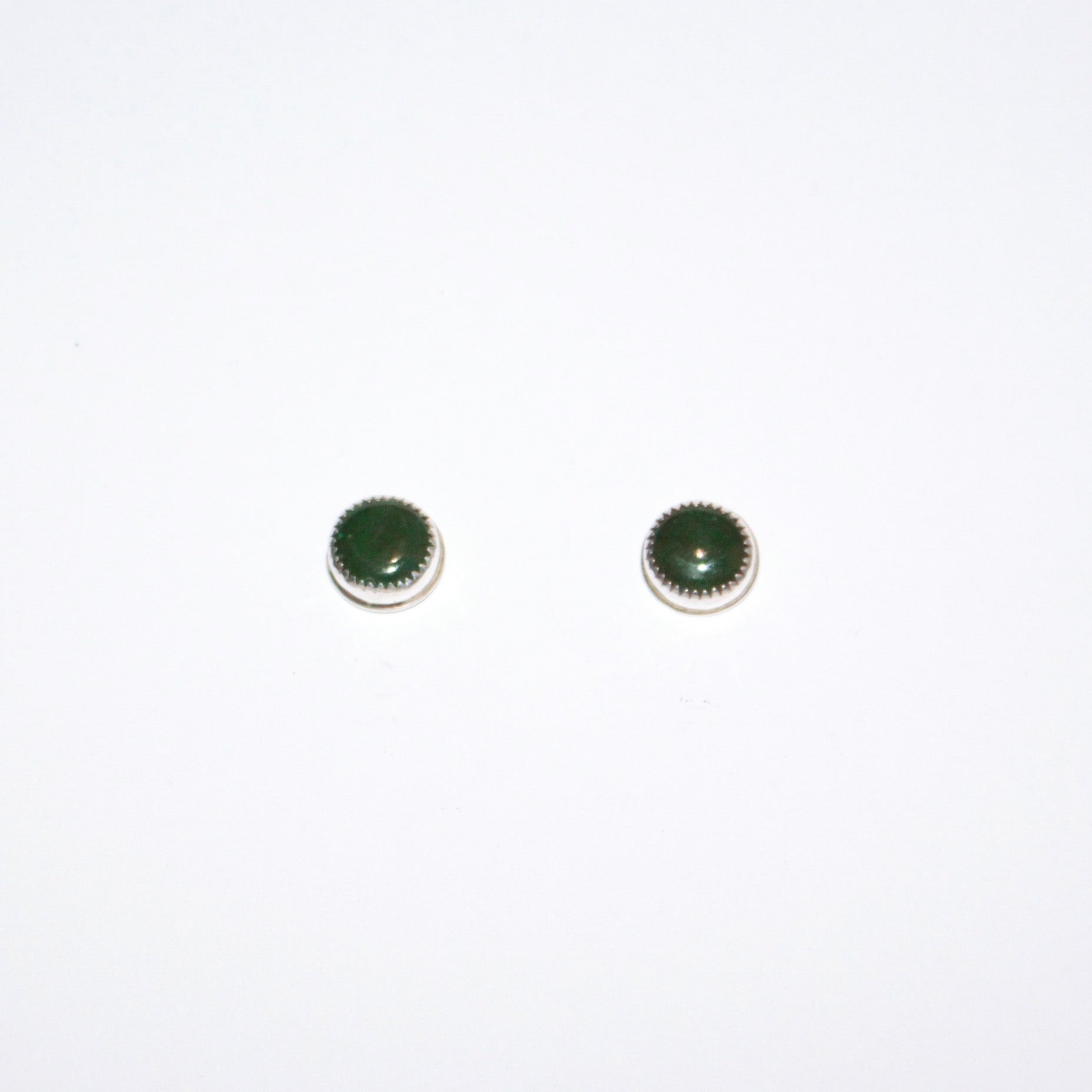 A pair of small round stud earrings with dark green cabochon stones in silver, shown on a plain white background.