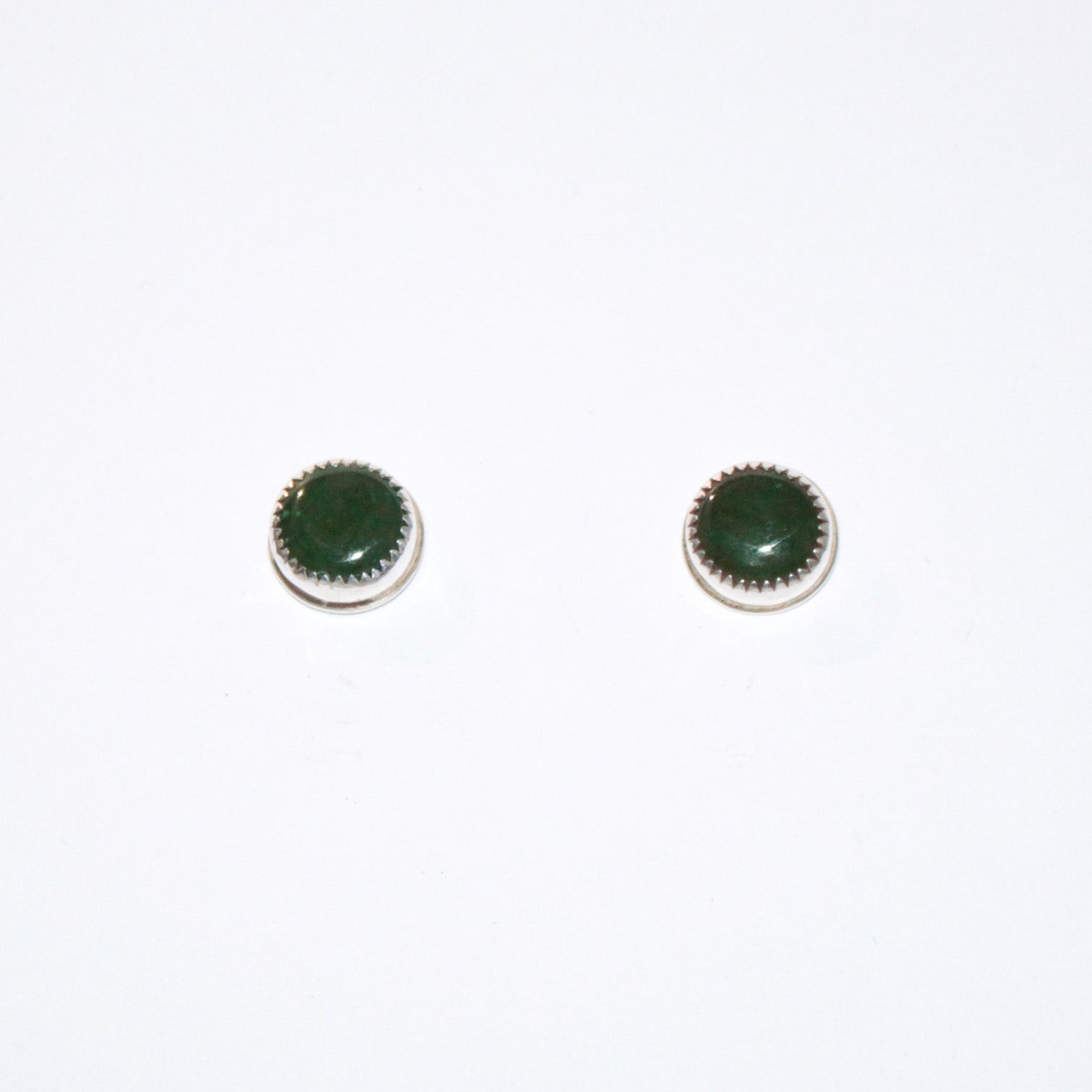 A pair of round stud earrings with dark green cabochon stones set in silver bezel settings, shown on a plain white background.