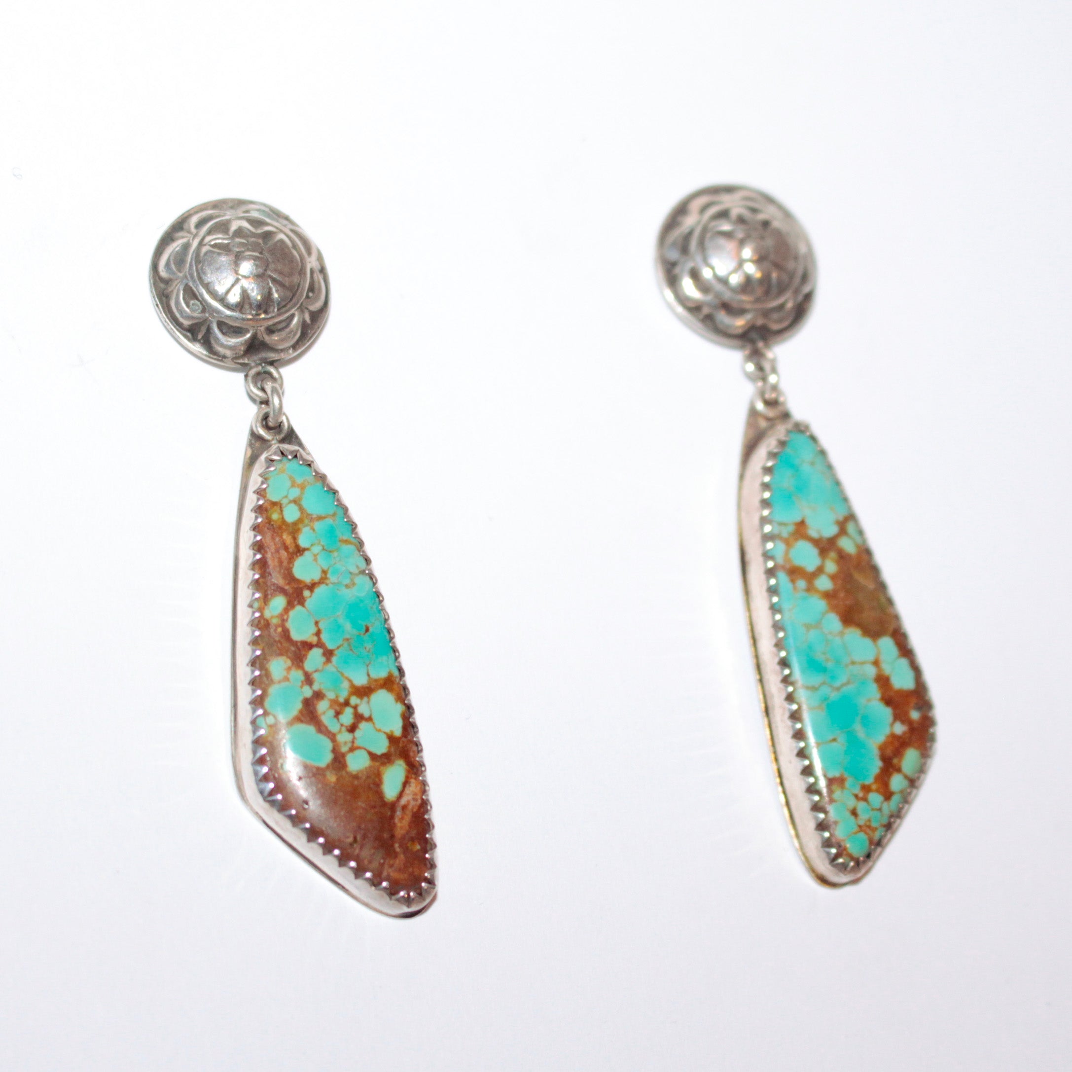 A pair of silver dangle earrings featuring number-8 turquoise inlay, photographed on a clean white background.
