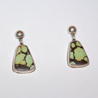 A pair of sterling silver dangle earrings featuring organic-shaped Bao Canyon turquoise stones with light green and dark brown matrix patterns, suspended from round silver studs on a plain white background.