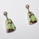 A pair of sterling silver stud earrings featuring irregular, organic-shaped Bao Canyon turquoise stones with a light green and dark brown marbled pattern, set in silver bezel settings with round silver studs.