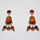 A pair of sterling silver dangle earrings featuring natural orange-brown Cherry Carnelian stones in a geometric Southwestern-style design, displayed on a clean white background.
