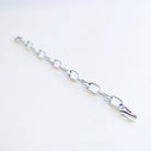A silver metal link chain with elongated oval links and a hook clasp, photographed on a plain white background.