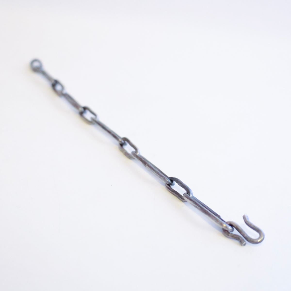 A dark grey Sterling Silver chain link bracelet with a hook clasp, photographed on a plain white background.