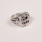 A sterling silver signet ring with a highly textured, openwork Savoir Vivre initials design on the face and a polished band, shown on a plain off-white background.